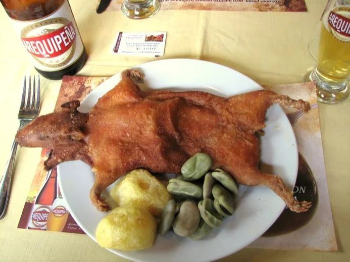 Ah..cold beer and a roasted Guinea Pig hot the spot in Cusco, Peru.