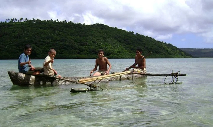 Children playing along the Tongan shore
