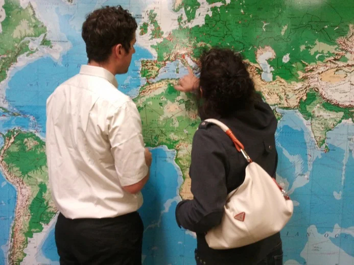 Colin looking at our world map with a guest