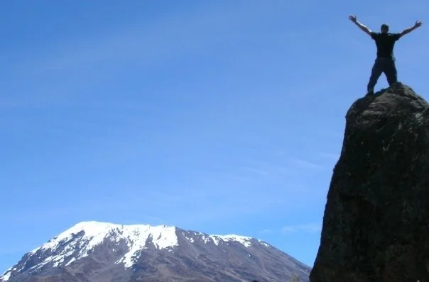 Traveler Greg Taylor surveys Kibo Peak, Mt Kilimanjaro
