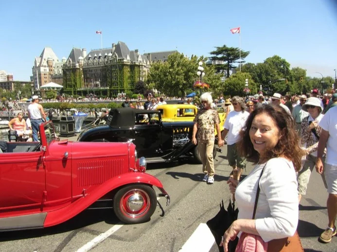 Restored 1932 Fords and pre-1952 models converge in Victoria's Inner Harbour on Deuce Days. Guide Elizabeth pictured.