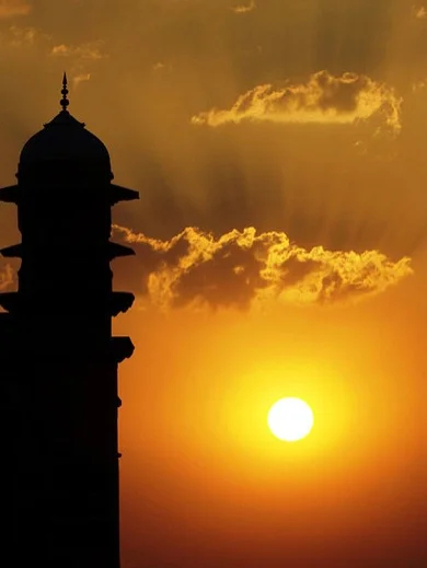 Taj Mahal Minaret silhouetted at sunset