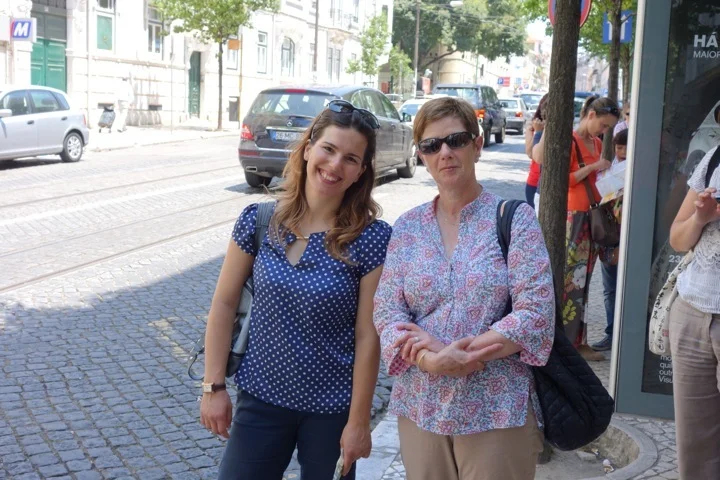 Catia (left) with a traveler in Lisbon
