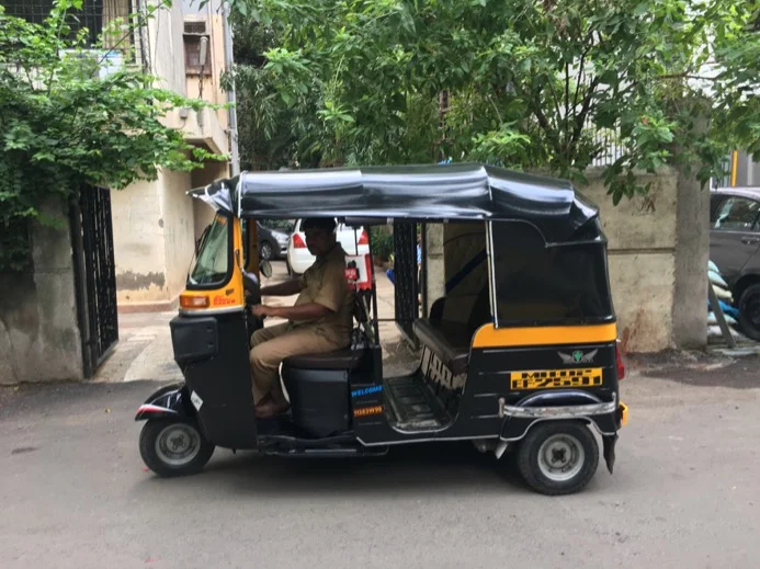 A tuk tuk and driver in Mumbai