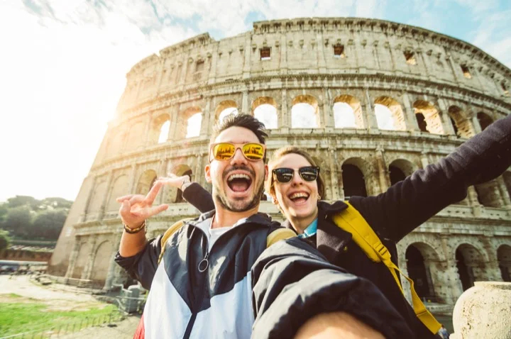 Couple standing in front of Rome Colesseum