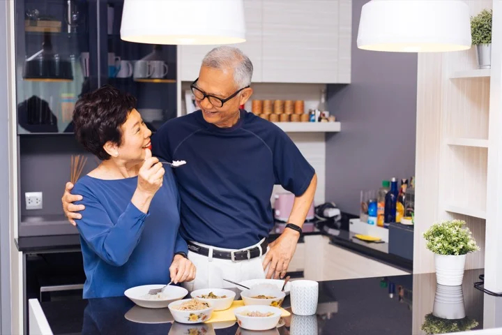 Senior Asian couple grandparents cooking together