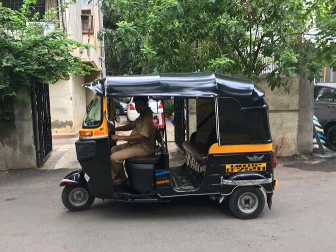 A tuk tuk and driver in Mumbai