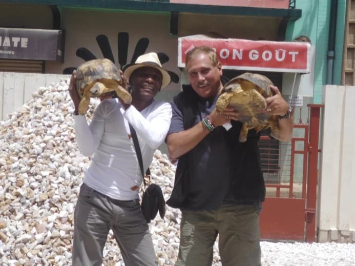My guest is from USA. we are visiting a mineral shop in Antsirabe and are meeting these two guys in the yard