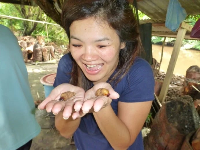 Holding Sago Worms for the first time on a jungle exploration tour