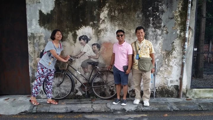 STREET ART MURAL - BROTHER AND SISTER ON BYCYCLE BY ERNST ZACHEREVIC