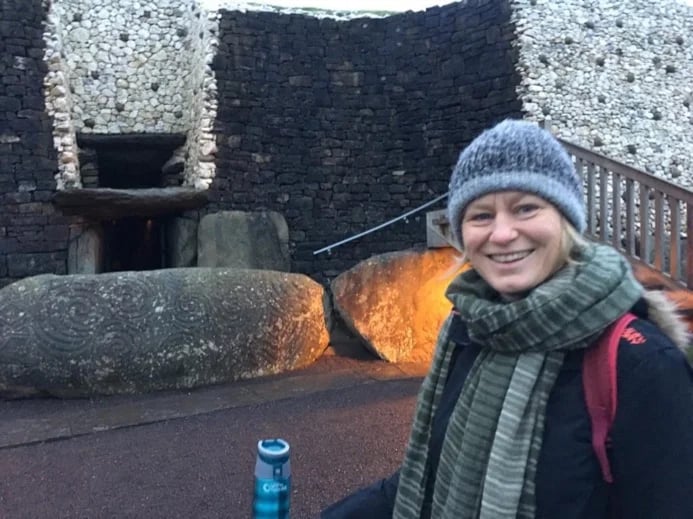 Mia outside Newgrange passage tomb at dawn on solstice day - Dec 21st.