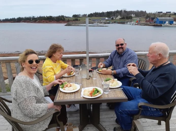 Enjoying lobster rolls on the deck of Carr's Oyster Bar & Restaurant