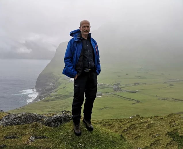 This is me standing on the trail to the famous Kallurin Lighthouse with the village of Trøllanes in the background.