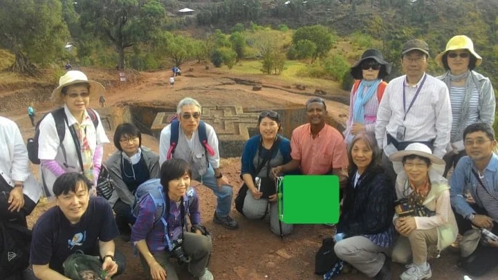 Me with visitors at the rock church of Lalibela behind us