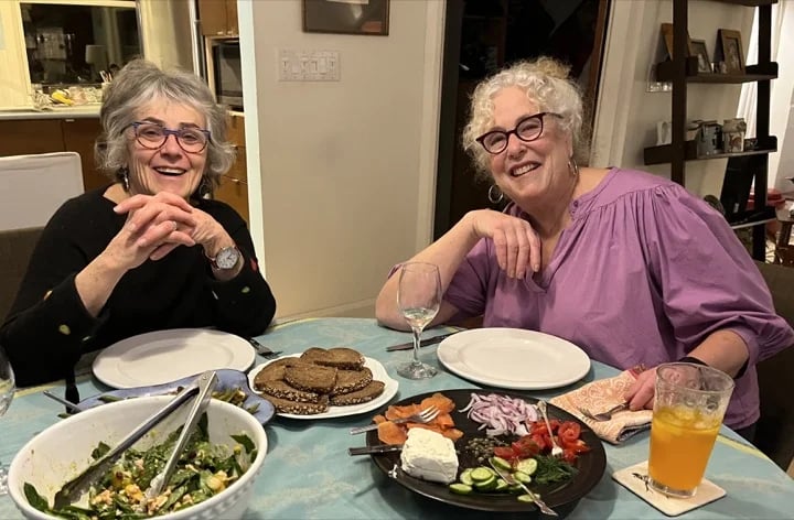 Guides Susan and Linda offer food and drink to guests on Tour 3