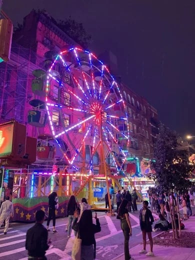 This brilliant Ferris Wheel changes colors on the corner of Grand and Baxter Streets during the San Gennaro Festival