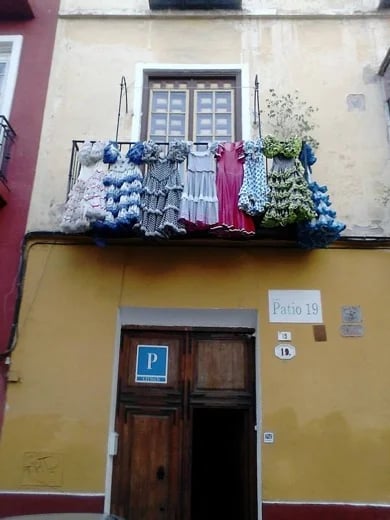 BALCONY WITH FLAMENCO DRESSES, SEVILLE.